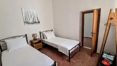 a bedroom with two beds and a mirror at Dimitra - Kattavia surf houses in Kattavía