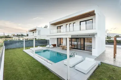 a white house with a swimming pool in the backyard at D&R Boutique Villas R in Gennadi