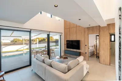 a living room with a couch and a television at D&R Boutique Villas R in Gennadi