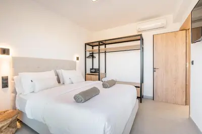 a bedroom with two beds with white pillows at D&R Boutique Villas R in Gennadi