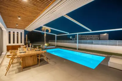 a swimming pool in the middle of a house at D&R Boutique Villas R in Gennadi