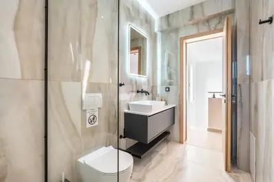 a bathroom with a toilet sink and a shower at D&R Boutique Villas R in Gennadi