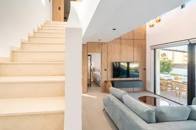 a living room with a couch and stairs at D&R Boutique Villas D in Gennadi