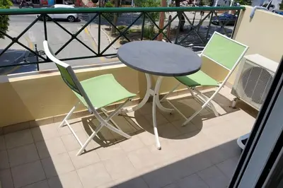 a table and two chairs sitting on a balcony at orange in Ialyssos