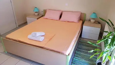 a bedroom with a bed with two towels on it at orange in Ialyssos