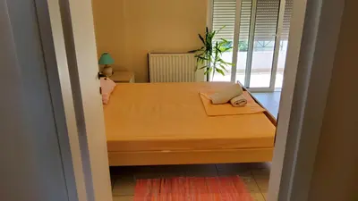 a bedroom with a bed with a laptop on it at orange in Ialyssos