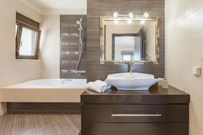 a bathroom with a sink and a tub and a mirror at Halide Luxury Villa in Ixia