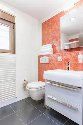 a bathroom with a white toilet and a sink at Halide Luxury Villa in Ixia