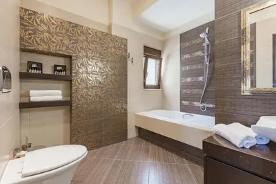 a bathroom with a tub and a toilet and a sink at Halide Luxury Villa in Ixia