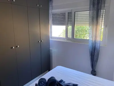 a bedroom with a bed and a window at Restaurant Maria Suites SunRise in Faliraki