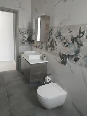 a bathroom with a toilet and a sink at Restaurant Maria Suites SunRise in Faliraki