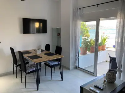a dining room with a table and chairs and a window at Restaurant Maria Suites SunRise in Faliraki