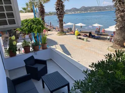 a view of the beach from a balcony of a resort at Restaurant Maria Suites SunRise in Faliraki