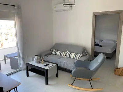 a living room with a couch and a chair at Restaurant Maria Suites SunRise in Faliraki