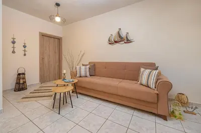 a living room with a couch and a table at Panormos Luxury House in Rhodes Town