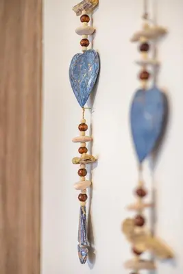 a group of dainty earrings hanging on a wall at Panormos Luxury House in Rhodes Town