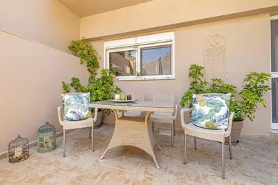 a patio with a table and chairs and a window at Panormos Luxury House in Rhodes Town