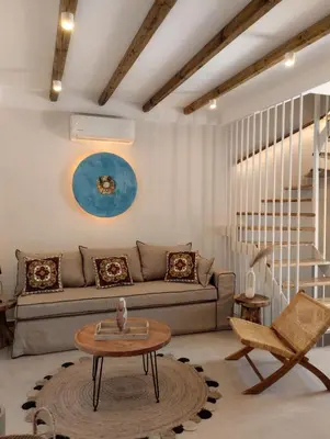 a living room with a couch and a table at Seaesta Villas in Koskinou