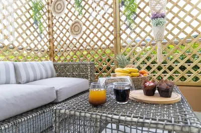 a table with a tray of fruit and drinks on a patio at Nikolias dream house in Ialyssos
