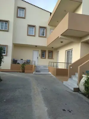 a large white building with stairs and a door at Nikolias dream house in Ialyssos