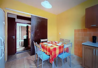 a dining room with a table and chairs in a kitchen at Rhodos town apartment in Rhodes Town