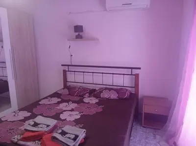 a bedroom with a bed with flowers on it at Rhodos town apartment in Rhodes Town