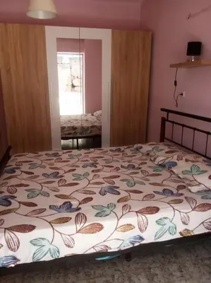 a bedroom with a bed with a floral bedspread at Rhodos town apartment in Rhodes Town