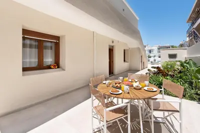 a wooden table on the balcony of a building at My Pixida Apartments in Rhodes Town