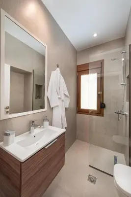 a bathroom with a sink and a mirror and a shower at My Pixida Apartments in Rhodes Town