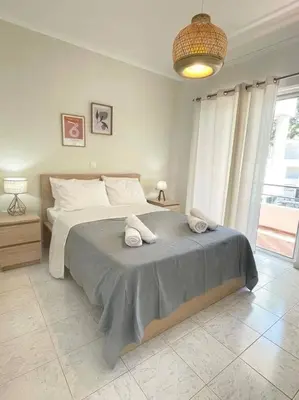 a bedroom with a bed with two towels on it at Gravity Ialysos Scandi Suite in Ialyssos