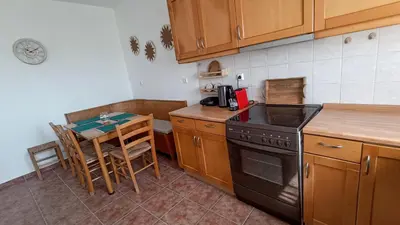 a kitchen with a table and a stove top oven at Kristallia - Kattavia surf houses in Kattavía