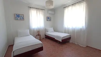 a bedroom with two beds and a window at Kristallia - Kattavia surf houses in Kattavía