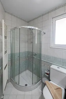 a bathroom with a shower with a toilet and a window at Luxury Villa Barbara Afandou Rhodes in Afantou