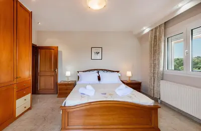 a bedroom with a bed with two towels on it at Luxury Villa Barbara Afandou Rhodes in Afantou