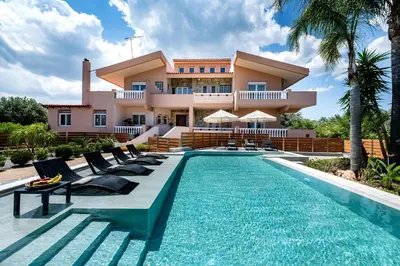 a villa with a swimming pool in front of a house at Luxury Villa Barbara Afandou Rhodes in Afantou