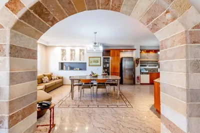 a kitchen and living room with a table and chairs at Luxury Villa Barbara Afandou Rhodes in Afantou