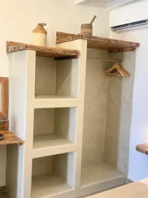 a book shelf in a room with shelves at ALEMINAS House 1 in Symi