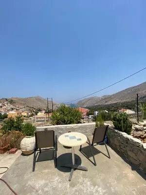 a table and two chairs sitting on a patio at ALEMINAS House 1 in Symi