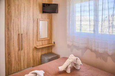 a bedroom with a bed with two towels at Davinci's Studios in Haraki