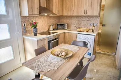 a kitchen with a wooden table with a bowl on it at Davinci's Studios in Haraki
