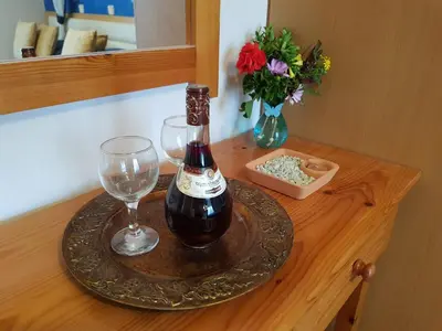 a bottle of wine and a glass on a table at Davinci's Studios in Haraki