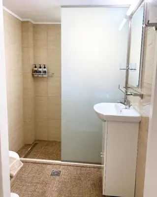 a bathroom with a sink and a shower at House of Helios in Pastida