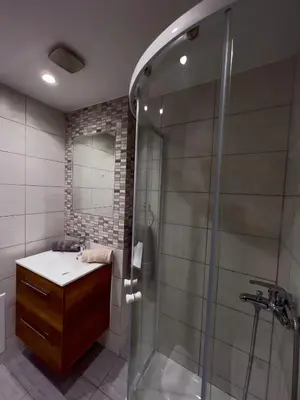 a bathroom with a shower and a sink and a glass shower stall at Villa AleNi Lindos in Líndos