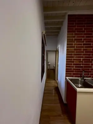 a kitchen with a sink and a brick wall at Villa AleNi Lindos in Líndos