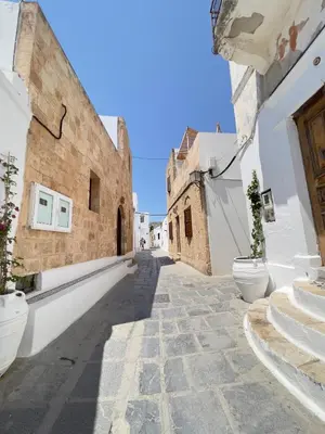 an alley in an old town with white buildings at Villa AleNi Lindos in Líndos