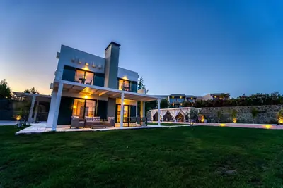 a large house with a lawn in front of it at Heliophos Villa Aelia in Kiotari