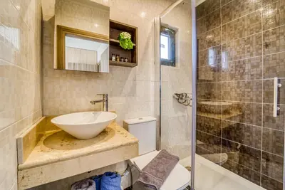 a bathroom with a sink and a toilet and a shower at Heliophos Villa Aelia in Kiotari
