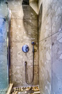 a shower in a bathroom with a glass door at Heliophos Villa Aelia in Kiotari