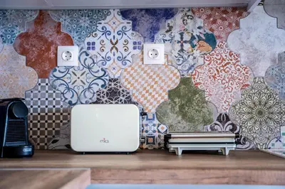 a room with a wall with a wallpaper with a toaster at Heliophos Villa Aelia in Kiotari