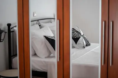 a bedroom with a bed with white sheets and pillows at Villa Emerald in Asgourou